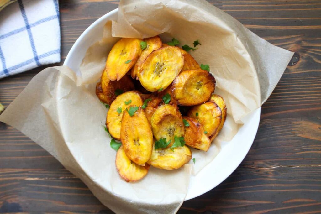 Remove the fried plantain slices from the oil and place them flat