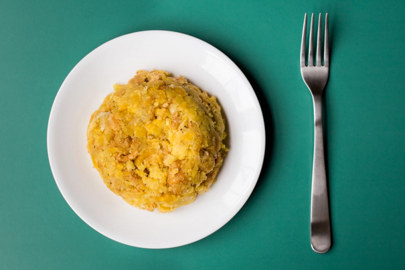 Mofongo on a plate with fork on the side