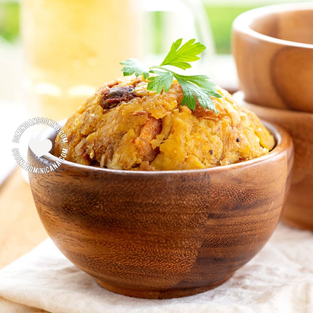 Mofongo is a dish made from fried green plantains that are mashed with garlic, olive oil, and crispy pork cracklings (chicharrones).