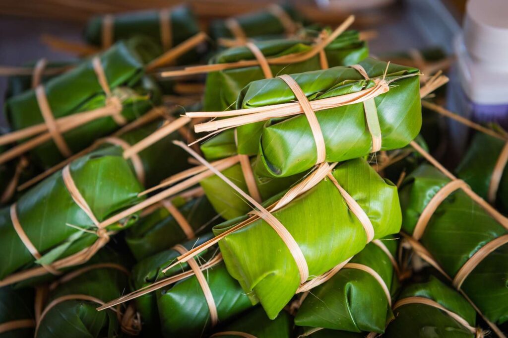 wrapping food in banana leaves before cooking
