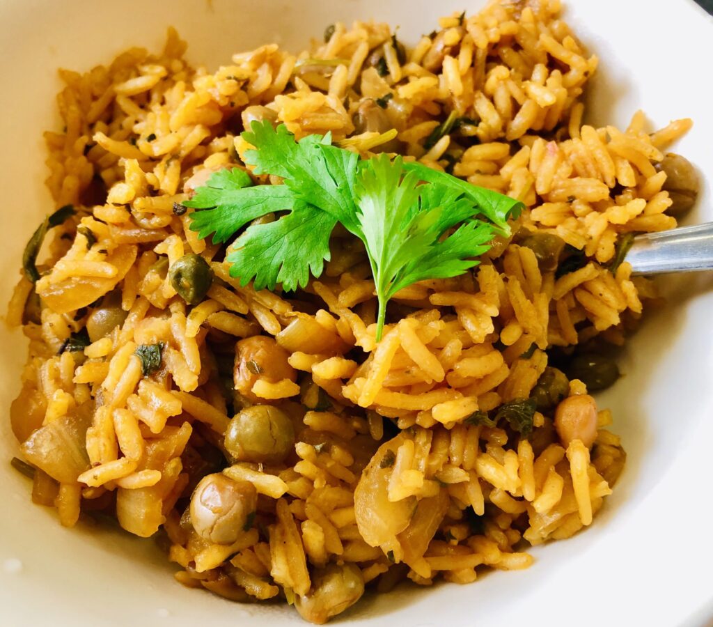Puerto Rico is a place where many cultures have come together, and Arroz con Gandules is a perfect example of this blend. The Taino Indians, Spanish settlers, and Africans all lived on the island and shared their ways of cooking. This dish is like a painting that shows the colors of all these people.