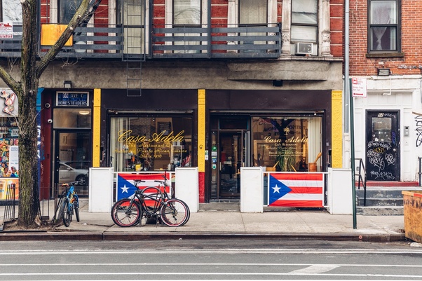 In cities like Miami and New York, Puerto Rican immigrants have created little pockets of their island’s culture. They open restaurants and food stands where they serve up dishes like Arroz con Gandules. These places become more than just spots to eat; they’re community centers where people can gather, share stories, and keep their traditions alive.