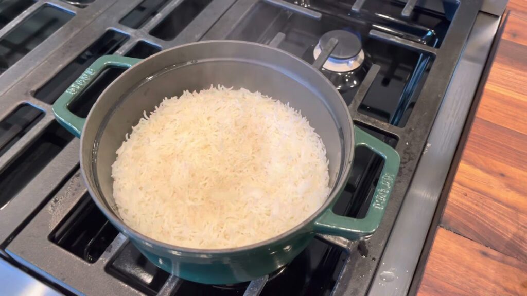 Start by boiling the water and rice together on high heat.