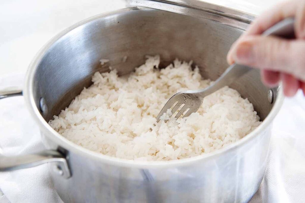After resting, use a fork to gently fluff the rice from the bottom up.