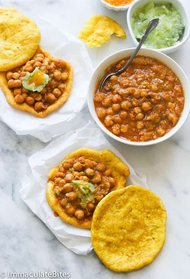 Now that you have your bara and channa ready, it’s time to put them together:

Take one bara and lay it flat on a plate.

Spoon some of the channa on top of the bara. How much? That’s up to you, but usually, two or three spoonfuls are just right.

If you like, you can add some sauce now. Many people love tamarind sauce or cucumber chutney on their doubles.

Now, take another bara and place it on top, like a sandwich.

And there you have it—your very own double! It’s best enjoyed warm, so don’t wait too long to eat it.