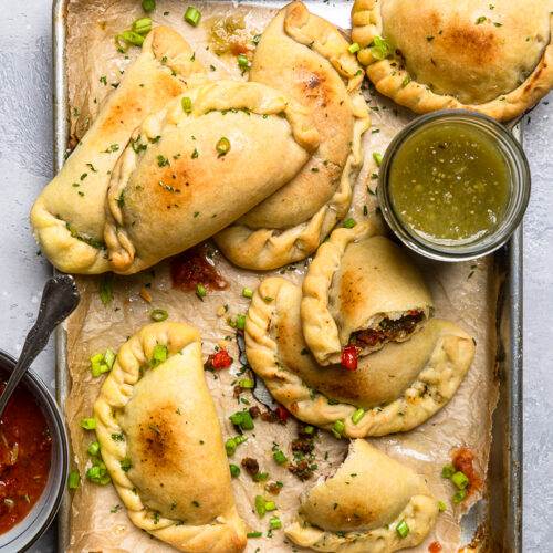 Cross-section of plant-based empanadas filled with jackfruit and black beans.