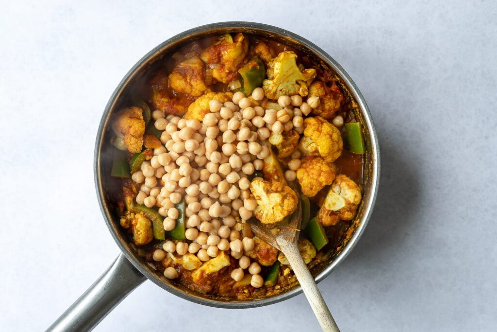 Cauliflower and chickpeas cooked in a spiced curry sauce for empanada filling.